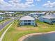 Aerial view of a blue lakeside condo community with palm trees, sidewalks and lake views at 5739 Sabal Trace Dr # 102, North Port, FL 34287