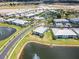 Panoramic aerial showcasing blue condos, water features, sidewalks, and lush palm tree landscaping at 5739 Sabal Trace Dr # 102, North Port, FL 34287