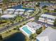 An aerial view of the blue condominiums, pool, landscaping, and lakes in this community at 5739 Sabal Trace Dr # 102, North Port, FL 34287