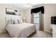 Comfortable bedroom featuring neutral tones, a ceiling fan, and a window dressed with curtains at 5739 Sabal Trace Dr # 102, North Port, FL 34287