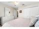 Well-lit bedroom showcases a white dresser with mirror and a closet with double doors at 5739 Sabal Trace Dr # 102, North Port, FL 34287
