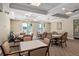 Comfortable clubhouse area furnished with tables and chairs, with views of the pool at 5739 Sabal Trace Dr # 102, North Port, FL 34287