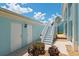 Exterior view with white steps leading to the entrance, flanked by white garage doors and manicured landscape at 5739 Sabal Trace Dr # 102, North Port, FL 34287
