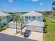 Beautiful light blue two-story home with multiple garages, a metal roof, and a well-manicured lawn at 5739 Sabal Trace Dr # 102, North Port, FL 34287
