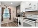 Bright kitchen featuring white cabinetry, modern appliances, and a cozy breakfast nook area at 5739 Sabal Trace Dr # 102, North Port, FL 34287