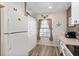 Well-lit kitchen featuring white cabinets, a window view, and a compact design at 5739 Sabal Trace Dr # 102, North Port, FL 34287