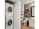 Convenient laundry area next to bathroom featuring stackable washer and dryer, optimizing space at 5739 Sabal Trace Dr # 102, North Port, FL 34287