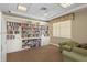 Charming library space with an extensive bookshelf and comfortable seating area at 5739 Sabal Trace Dr # 102, North Port, FL 34287
