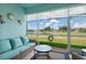 Relaxing screened patio overlooking a peaceful lake and well-manicured lawn at 5739 Sabal Trace Dr # 102, North Port, FL 34287