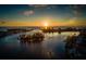 Scenic aerial view of waterfront community at sunset, with boat navigating through the waterways at 5853 Semolino St, Nokomis, FL 34275