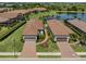 Aerial view of the neighborhood with well-manicured lawns and landscaping, and a serene lake at 5853 Semolino St, Nokomis, FL 34275