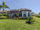 The house has a spacious backyard, with a screened-in lanai and a mature palm tree at 5853 Semolino St, Nokomis, FL 34275