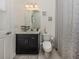 Well-lit bathroom featuring a vanity, toilet, and decorative shower curtain at 5853 Semolino St, Nokomis, FL 34275