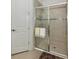 Bathroom showcases a tiled shower with glass door and neutral color palette at 5853 Semolino St, Nokomis, FL 34275