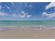 Serene beach view with blue skies, calm water, and soft sand, inviting relaxation and tranquility at 5853 Semolino St, Nokomis, FL 34275