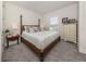 Comfortable bedroom with a four-poster bed, soft carpet, and plenty of natural light at 5853 Semolino St, Nokomis, FL 34275