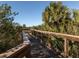 Scenic community wooden walkway offers an elevated view of lush green landscape, a serene environment for residents at 5853 Semolino St, Nokomis, FL 34275
