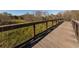 Scenic community wooden walkway surrounded by lush green landscape, offering a serene environment for residents at 5853 Semolino St, Nokomis, FL 34275