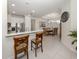A bar area leading to an elegant dining room with seating for eight and decorative clock at 5853 Semolino St, Nokomis, FL 34275