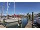 Sailboats docked on a wooden pier, offering waterfront property access and boating opportunities at 5853 Semolino St, Nokomis, FL 34275
