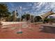 Interactive splash fountain on brick surface with shade structure, benches, and palm trees around at 5853 Semolino St, Nokomis, FL 34275
