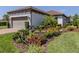 Charming home with a two-car garage, brick driveway, and meticulously maintained landscaping at 5853 Semolino St, Nokomis, FL 34275