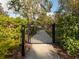 Gated community entrance to the walkway with manicured greenery providing security and beauty for residents at 5853 Semolino St, Nokomis, FL 34275