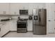 Bright kitchen boasts stainless appliances, granite countertops, and crisp white cabinetry at 5853 Semolino St, Nokomis, FL 34275