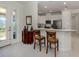 View of kitchen and entrance with breakfast bar and chairs at 5853 Semolino St, Nokomis, FL 34275