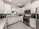 Beautiful kitchen with white cabinets, granite countertops, and stainless steel appliances at 5853 Semolino St, Nokomis, FL 34275