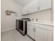 Laundry room includes a washing machine, dryer, sink, and built-in cabinets at 5853 Semolino St, Nokomis, FL 34275