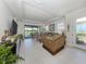 Bright living room with sliding glass doors to outdoor patio, plush seating, and decor at 5853 Semolino St, Nokomis, FL 34275