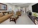 Comfortable living room with plush seating, decorative art, and access to kitchen at 5853 Semolino St, Nokomis, FL 34275