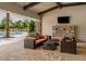 Comfortable outdoor living space with lounge seating, a fireplace, and views of the community pool at 5853 Semolino St, Nokomis, FL 34275