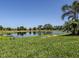 Beautiful view of the lush green pond and manicured lawns on a sunny day at 5853 Semolino St, Nokomis, FL 34275