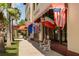 Quaint shopping district featuring benches and international flags, inviting visitors to explore local shops at 5853 Semolino St, Nokomis, FL 34275