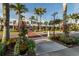 Charming street view of storefronts with manicured landscaping and mature palm trees in a vibrant neighborhood at 5853 Semolino St, Nokomis, FL 34275