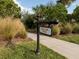 Legacy Trail access sign near a paved path surrounded by manicured landscaping, trees, and grassy areas at 5853 Semolino St, Nokomis, FL 34275