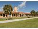Exterior of historic train station with terra cotta roof, arched walkways, and well-kept lawn at 5853 Semolino St, Nokomis, FL 34275