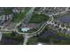Aerial view of a community with a pool, tennis courts, a pond, and surrounded by single-Gathering homes at 5966 Willows Bridge Loop, Ellenton, FL 34222