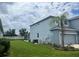 Side view of home featuring a screened-in porch, a garage, and a well-manicured backyard at 5966 Willows Bridge Loop, Ellenton, FL 34222