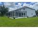 Backyard featuring a screened-in porch, a pool, and a well-manicured lawn at 5966 Willows Bridge Loop, Ellenton, FL 34222