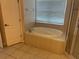 Bright bathroom featuring a soaking tub with tile surround and tiled floor at 5966 Willows Bridge Loop, Ellenton, FL 34222