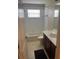 Bathroom featuring a tiled shower-tub combo, toilet, and vanity with storage and dark bathmat at 5966 Willows Bridge Loop, Ellenton, FL 34222
