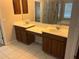 Bathroom featuring double sinks, wood cabinets, vanity, and tiled floor at 5966 Willows Bridge Loop, Ellenton, FL 34222