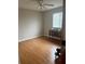 A bedroom featuring neutral walls, wood-look flooring, and a ceiling fan providing a blank canvas for personalization at 5966 Willows Bridge Loop, Ellenton, FL 34222