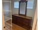 Spacious walk-in closet with wood floors and custom adjustable shelving at 5966 Willows Bridge Loop, Ellenton, FL 34222