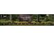 Stone community entrance sign to Covered Bridge Estates surrounded by greenery at 5966 Willows Bridge Loop, Ellenton, FL 34222