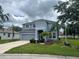 Charming two-story home with a well-manicured lawn and a two-car garage showcasing beautiful curb appeal at 5966 Willows Bridge Loop, Ellenton, FL 34222