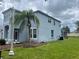 Exterior side view of a two-story home that has a screened-in porch and landscaped yard at 5966 Willows Bridge Loop, Ellenton, FL 34222